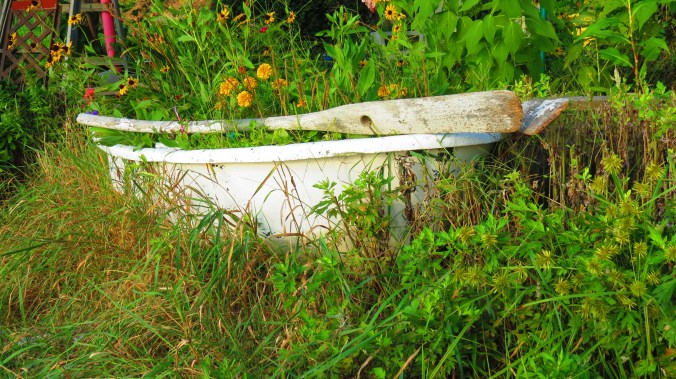 An old dinghy, now a planter, feels at home in this shore-hugging garden.