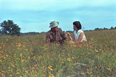 President Johnson and First Lady Ladybird Johnson share a quiet moment in a field of wildflowers.   Photo courtesy of LBJ Presidential Library.